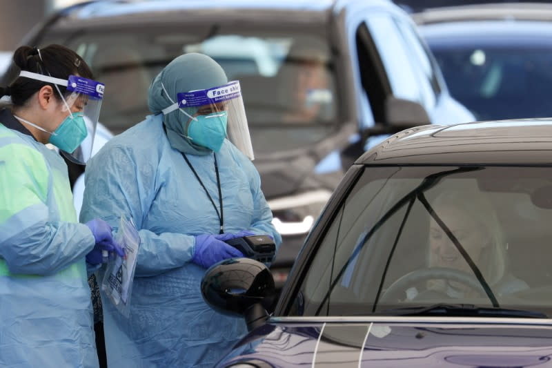 FILE PHOTO: Medical workers administer tests at the Bondi Beach COVID-19 testing centre in Sydney