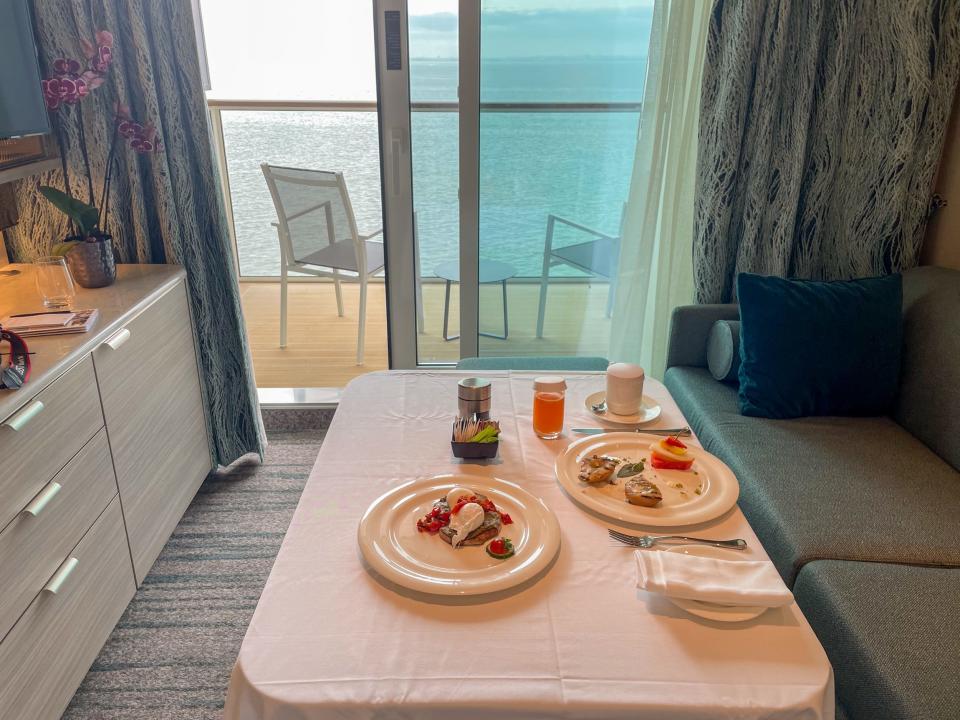 plates of food next to balcony overlooking ocean