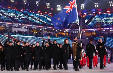 Feb 9, 2018; Pyeongchang, South Korea; Beau-James Wells of New Zealand carries the national flag with delegates during the Pyeongchang 2018 Olympic Winter Games Opening Ceremony at Pyeongchang Olympic Stadium. Mandatory Credit: Rob Schumacher-USA TODAY Sports