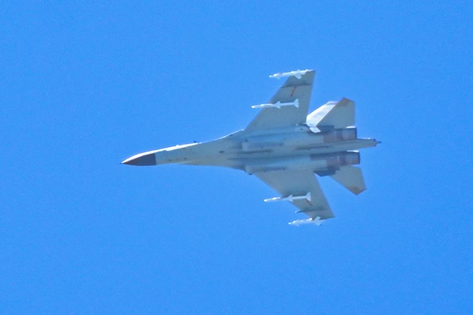 A Chinese military jet flies over Pingtan island, one of mainland China’s closest point from Taiwan, in Fujian province on 5 August 2022 (AFP via Getty Images)