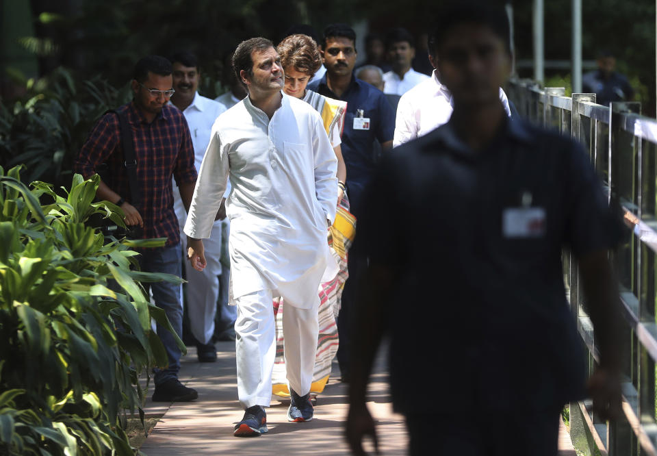 Congress party President Rahul Gandhi arrives for a Congress Working Committee meeting, followed by his sister Priyanka Gandhi Vadra, in New Delhi, India, Saturday, May 25, 2019. The BJP's top rival, led by Gandhi, won 52 seats. (AP Photo/Altaf Qadri)