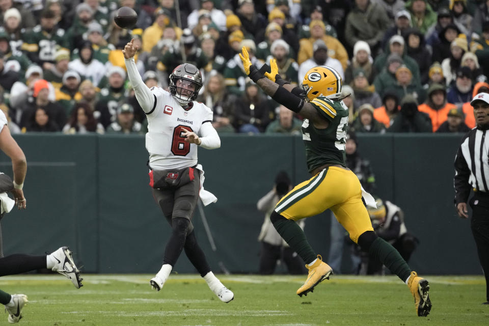 Tampa Bay Buccaneers quarterback Baker Mayfield (6) throws a pass as he is pressured by Green Bay Packers linebacker Rashan Gary, right, during the second half of an NFL football game, Sunday, Dec. 17, 2023, in Green Bay, Wis. (AP Photo/Morry Gash)