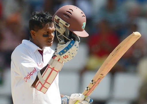 West Indies batsman Shivarine Chanderpaul celebrates his 10,000th test run during the fourth day of the third test match between the West Indies and Australia in Roseau, Dominica