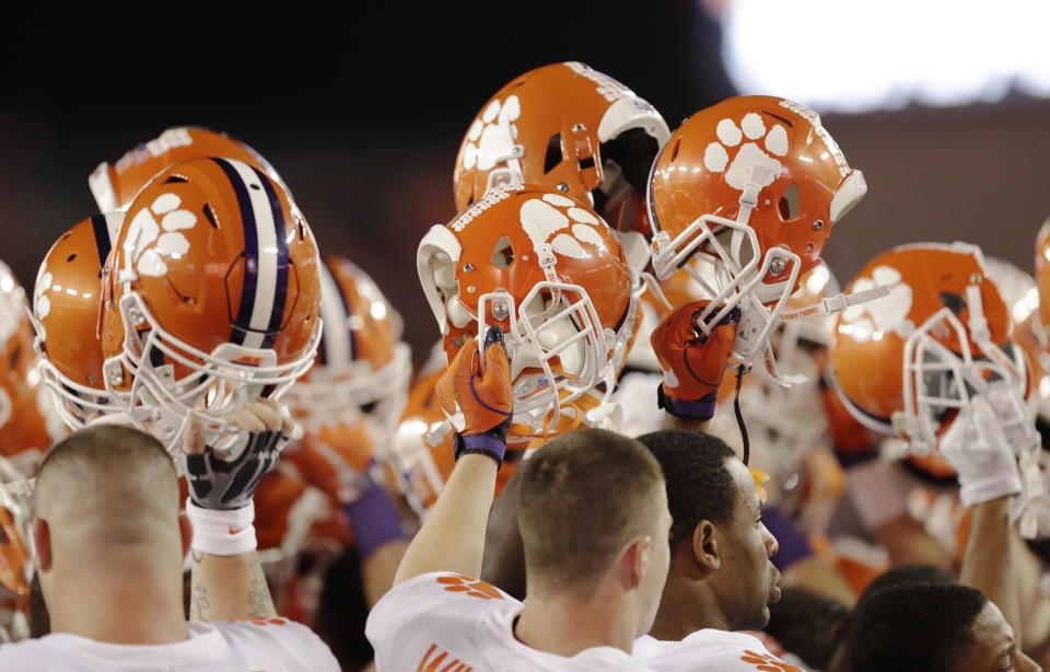 Clemson players hold up their helmets before the NCAA college football playoff championship game against Alabama Monday, Jan. 9, 2017, in Tampa, Fla. (AP Photo/Chris O'Meara)