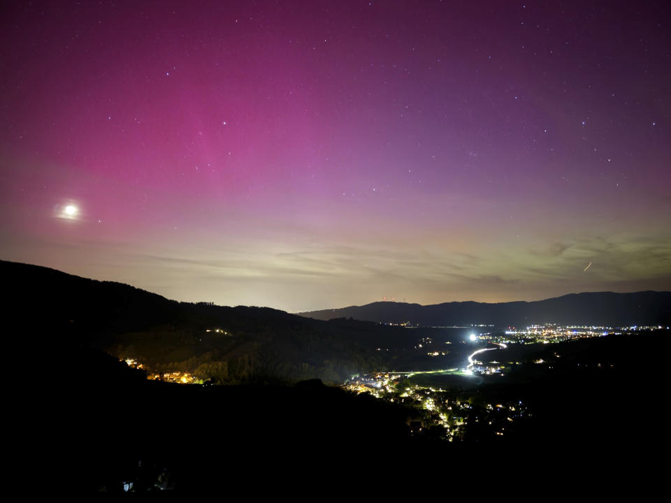 Northern lights appear over the Dreisamtal valley in the Black Forest near Freiburg, Germany, Friday evening, May 10, 2024. (Valentin Gensch/dpa via AP)