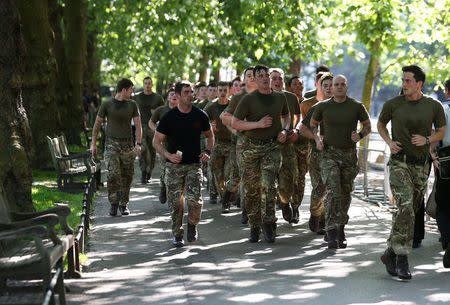 Soldiers run through St James's park in London, Britain, May 25, 2017. REUTERS/Neil Hall