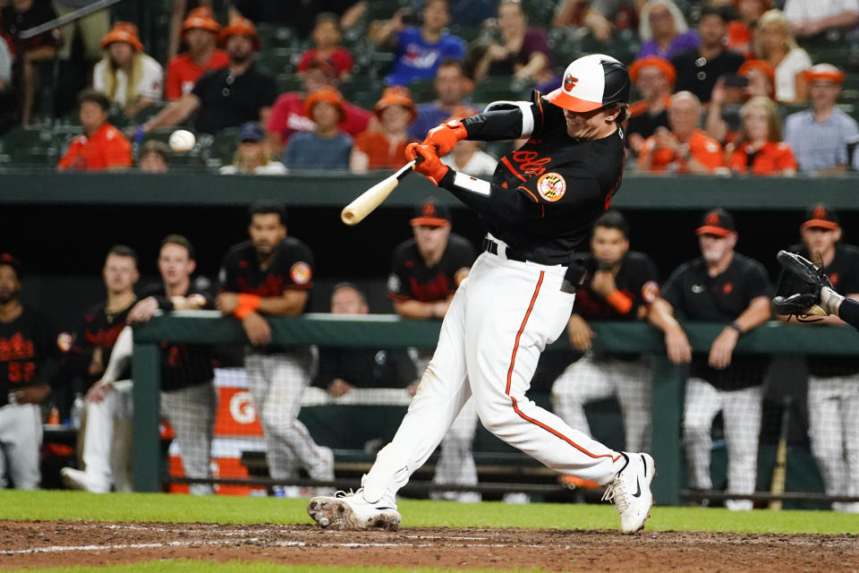 Baltimore Orioles' Adley Rutschman connects for an RBI single to score Rougned Odor during the ninth inning of a baseball game against the Los Angeles Angels, Friday, July 8, 2022, in Baltimore. The Orioles won 5-4. (AP Photo/Julio Cortez)