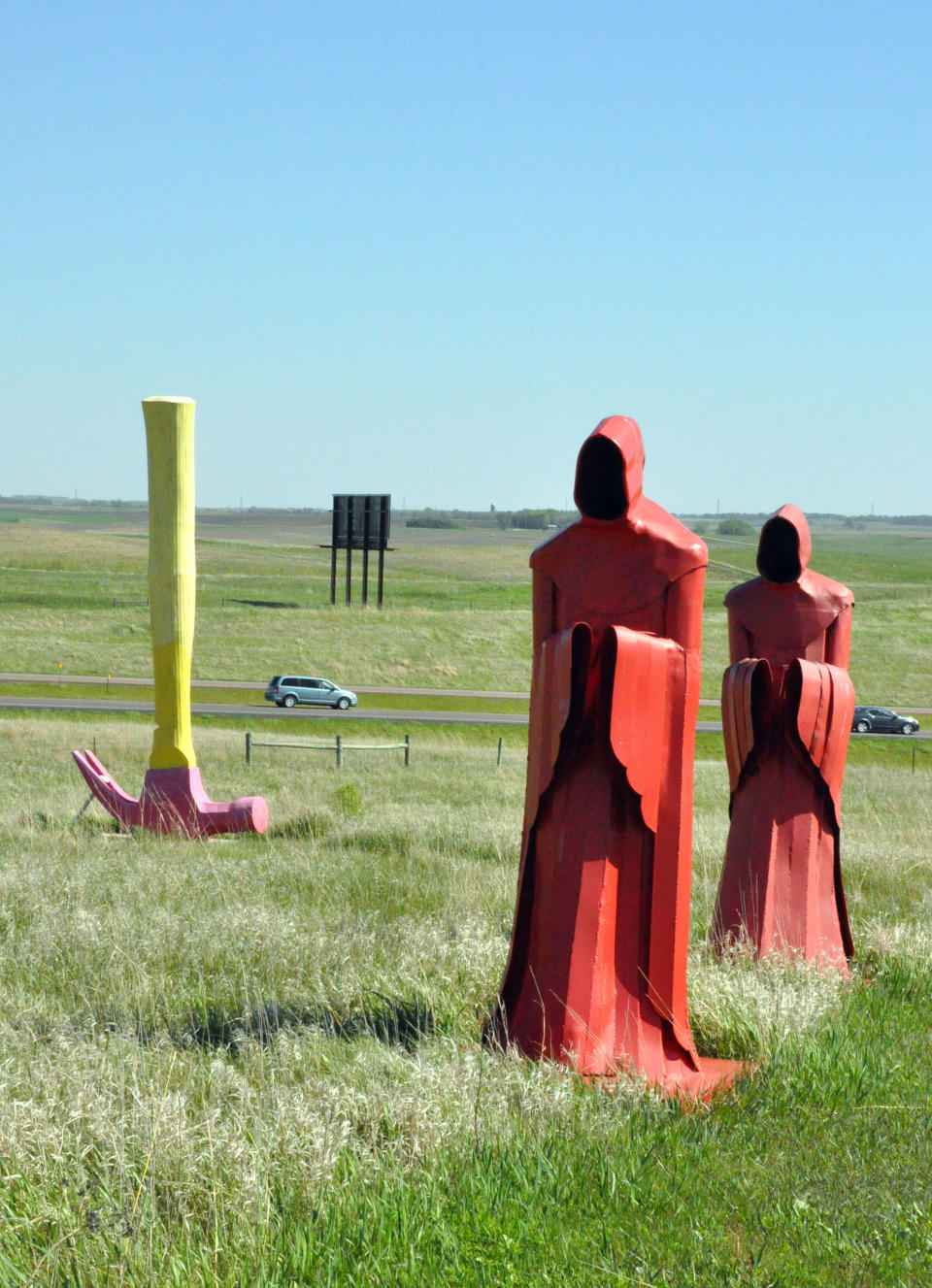 In this May 10, 2012 photo, a pair of monks and an upside-down hammer stand firm in the breeze as cars whiz by Porter Sculpture Park, in Montrose, S.D. The roadside attraction off Interstate 90 features more than 40 metal sculptures. The park’s signature piece is a 60-foot-tall Egyptian-style bull’s head that stares down at motorists as they head out to South Dakota’s Black Hills. Wayne Porter spent three years creating the 25-ton monstrosity out of railroad tie plates, dubbing it “The World’s Largest Bull’s Head” on a nearby billboard. (AP Photo/Dirk Lammers)