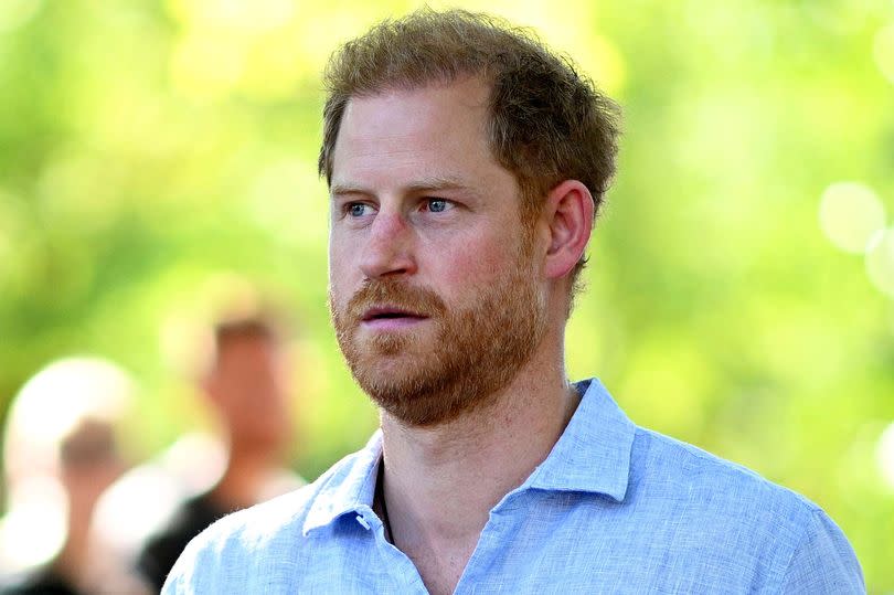 Prince Harry, Duke of Sussex looks on during day six of the Invictus Games Dusseldorf. He's wearing a light blue shirt