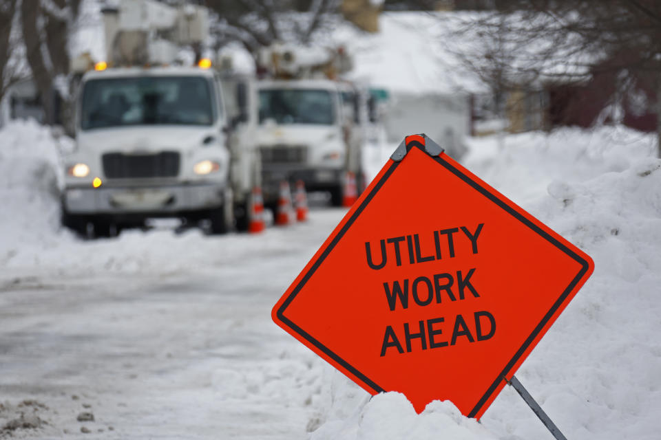 Utility worker trucks parked in a neighborhood after a winter storm rolled through Western New York Tuesday, Dec. 27, 2022, in Amherst, N.Y. (AP Photo/Jeffrey T. Barnes)