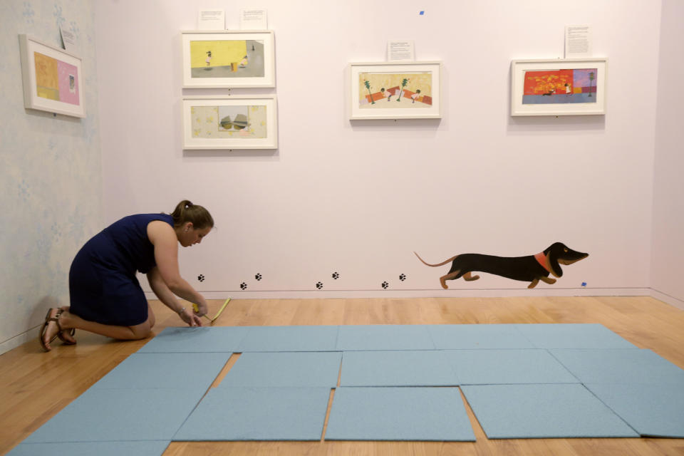 In this Tuesday, July 16, 2013 photo, registrar Sasha Makuka makes preparations for The Snowy Day and The Art Of Ezra Jack Keats exhibition at the National Museum of American Jewish History, in Philadelphia. The exhibition opened July 19. (AP Photo/Matt Rourke)