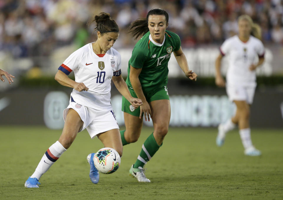 U.S. forward Carli Lloyd, left, controls the ball with Ireland midfielder Niamh Farrelly defending during the first half of an international friendly soccer match in Pasadena, Calif., Saturday, Aug. 3, 2019. (AP Photo/Alex Gallardo)