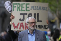 Britain's former leader of the Labour Party Jeremy Corbyn lsitens as supporters stage a demonstration in support of Julian Assange, outside the High Court, in London, Thursday, Oct. 28, 2021. The U.S. government is scheduled to ask Britain's High Court to overturn a judge's decision that WikiLeaks founder Julian Assange should not be sent to the United States to face espionage charges. A lower court judge refused extradition in January on health grounds, saying Assange was likely to kill himself if held under harsh U.S. prison conditions. (AP Photo/Frank Augstein)