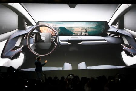 FILE PHOTO: Chairman of the Board, CEO and co-founder of Future Mobility, Carsten Breitfeld, speaks in front of a screen showing an image of a new Byton car at a press conference in Shanghai