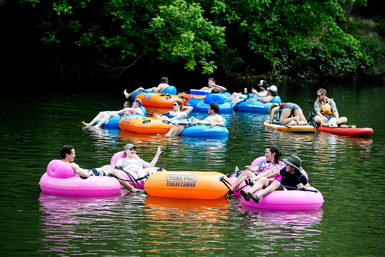 People cool off by floating down the French Broad River.