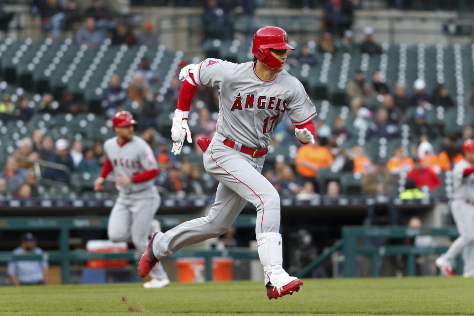 Los Angeles Angels' Shohei Ohtani runs to first on a groundout that scored Zack Cozart during the third inning of the team's baseball game against the Detroit Tigers in Detroit, Tuesday, May 7, 2019. (AP Photo/Paul Sancya)