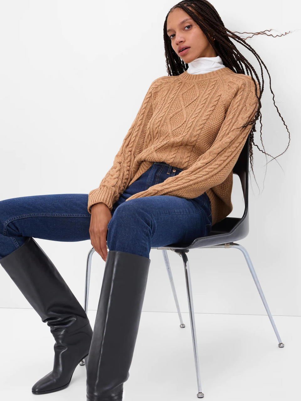 model wears tan Cable-Knit Crewneck Sweater. Image via Gap.