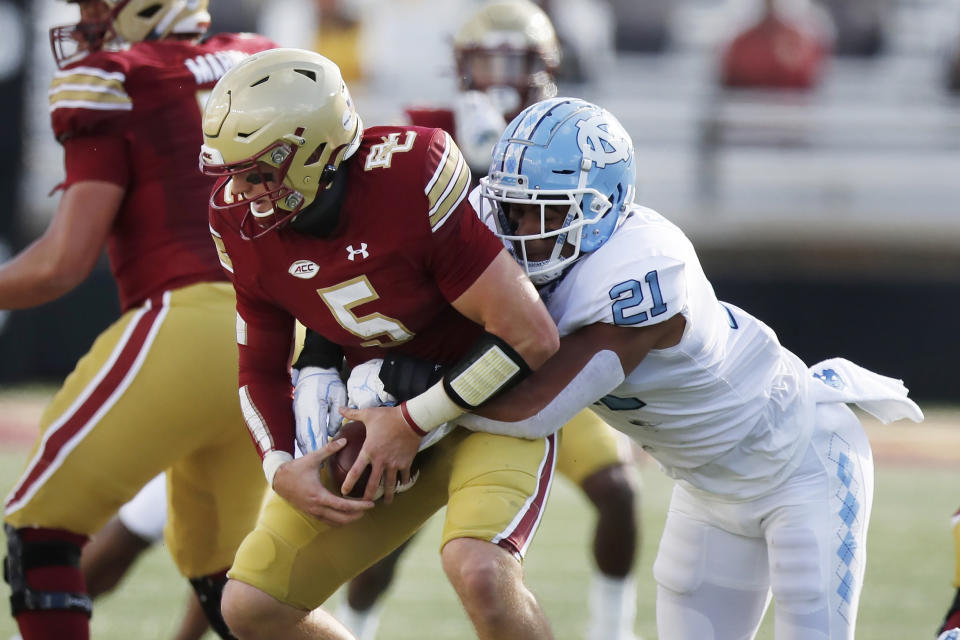 North Carolina linebacker Chazz Surratt (21) tries to strip the ball from Boston College quarterback Phil Jurkovec (5) during the first half of an NCAA college football game, Saturday, Oct. 3, 2020, in Boston. (AP Photo/Michael Dwyer)