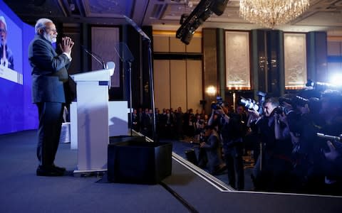 Mr Modi at the opening address of the Asia Security Summit.  - Credit: EDGAR SU/REUTERS