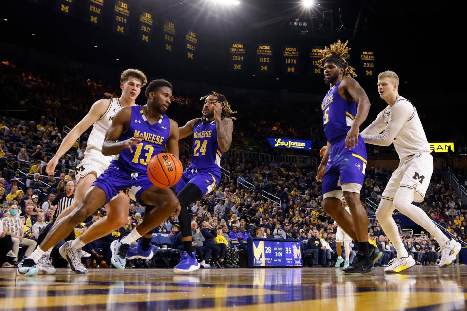 Dec 29, 2023; Ann Arbor, Michigan, USA; McNeese State Cowboys guard Shahada Wells (13) steals the ball from Michigan Wolverines forward Will Tschetter (42) in the first half at Crisler Center. Mandatory Credit: Rick Osentoski-USA TODAY Sports