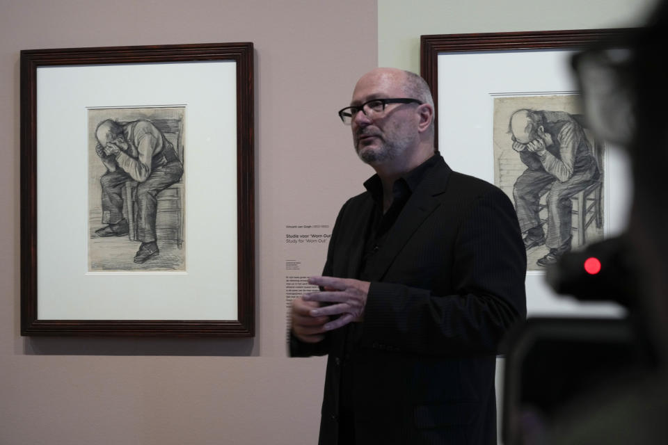Senior researcher Teio Meedendorp gestures during the presentation of Study for "Worn Out", left, a drawing by Dutch master Vincent van Gogh, dated Nov. 1882, on public display for the first time at the Van Gogh Museum in Amsterdam, Netherlands, Thursday, Sept. 16, 2021. (AP Photo/Peter Dejong)