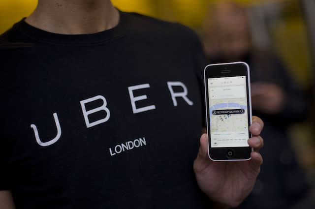 A Uber driver with an app on his phone, as they handed over a petition signed by over 205,000 people to Transport for London - ahead of a consultation by TfL on private hire in the capital - at 197 Blackfriars Road in London. PRESS ASSOCIATION Photo. Picture date: Tuesday December 22, 2015. Photo credit should read: Yui Mok/PA Wire