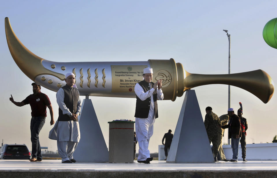 Pakistan Prime Minister Imran Khan, center, claps during the inauguration ceremony of Gurdwara Darbar Sahib in Kartarpur, Pakistan, Saturday, Nov. 9, 2019. Pakistan's prime minister has inaugurated a visa-free initiative that allows Sikh pilgrims from India to visit one of their holiest shrines. Khan opened the border corridor on Saturday as thousands of Indian pilgrims waited to visit the Kartarpur shrine. (AP Photo/K.M. Chaudary)