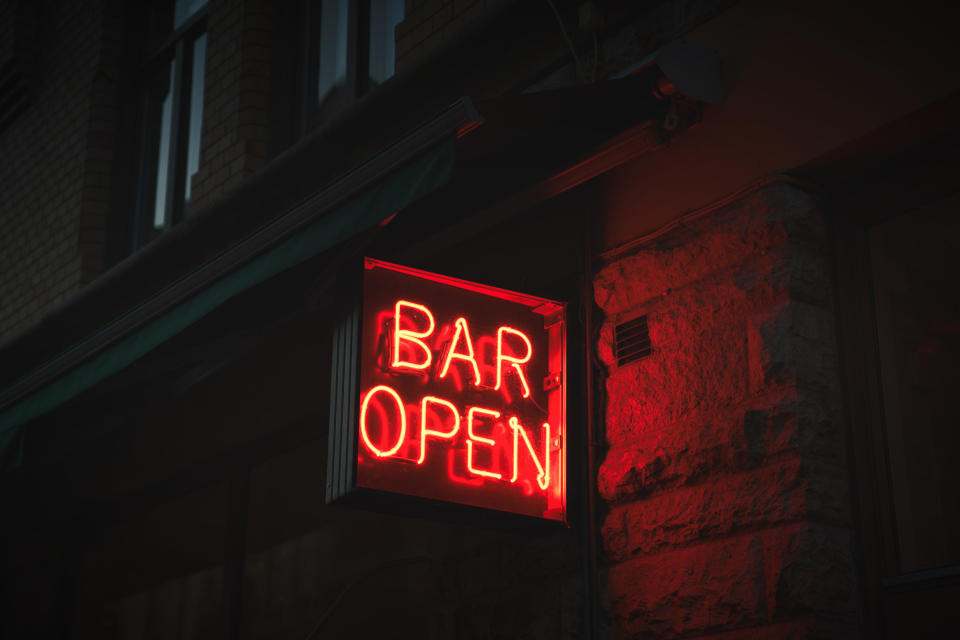 A red neon sign that reads "Bar open"