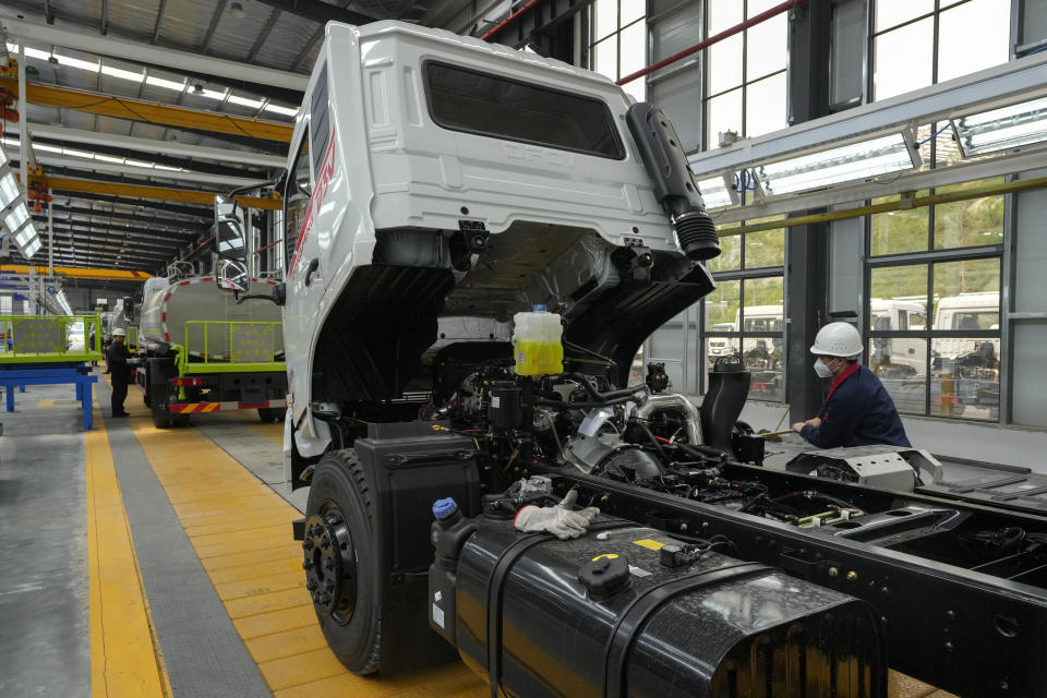 Workers assemble the Dongfeng truck at a manufacturing factory in Shiyan city in central China's Hubei Province on May 12, 2023. China's factory activity decelerated in May, a survey showed Wednesday, May 31 adding to signs its economic rebound after the end of anti-virus controls is slowing. (AP Photo/Andy Wong)