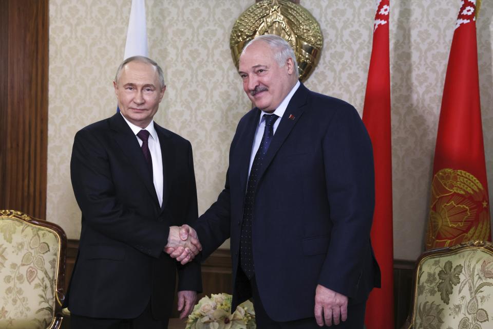 Russian President Vladimir Putin, left, and Belarusian President Alexander Lukashenko shake hands during their meeting at an international airport in Minsk, Belarus, Thursday, May 23, 2024. (Mikhail Metzel/Sputnik/Kremlin Pool Photo via AP)