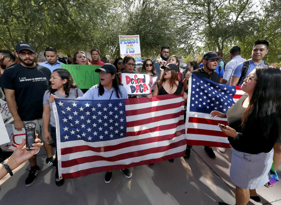 DACA supporters march to the Immigration and Customs Enforcement office to protest shortly after U.S. Attorney General Jeff Sessions’ announcement that the Deferred Action for Childhood Arrivals (DACA), will be suspended with a six-month delay, Tuesday, Sept. 5, 2017, in Phoenix. President Donald Trump on Tuesday began dismantling the Deferred Action for Childhood Arrivals, or DACA, program, the government program protecting hundreds of thousands of young immigrants who were brought into the country illegally as children. (AP Photo/Matt York)