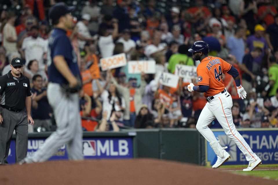 Houston Astros' Yordan Alvarez (44) runs the bases after hitting a two-run home run off Seattle Mariners starting pitcher Yusei Kikuchi, left, during the third inning of a baseball game Friday, Aug. 20, 2021, in Houston. (AP Photo/David J. Phillip)