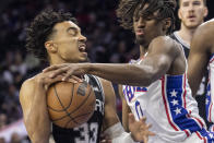 San Antonio Spurs guard Tre Jones (33) is fouled by Philadelphia 76ers guard Tyrese Maxey (0) during the first half on an NBA basketball game, Saturday, Oct. 22, 2022, in Philadelphia. (AP Photo/Laurence Kesterson)