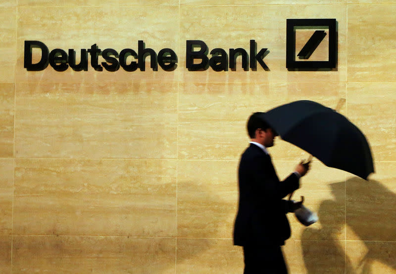 A man walking past a Deutsche Bank logo in London. (File photo: Reuters/Luke MacGregor)