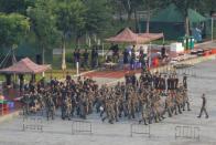 Chinese soldiers walk in formation on the grounds of the Shenzhen Bay Sports Center in Shenzhen across the bay from Hong Kong