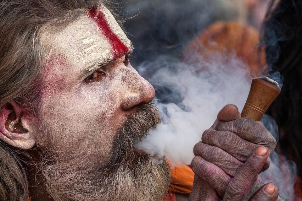 KATHMANDU, NEPAL - FEBRUARY 17:  A Shadu, or holy man, smokes cannabis with a chillum inside Pashupatinath temple during the celebration of the Maha Shivaratri festival on February 17, 2015 in Kathmandu, Nepal. 