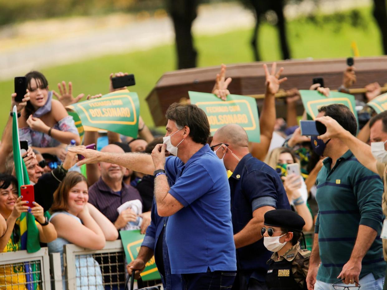 Brazil's President Jair Bolsonaro greets supporters during a protest against lockdown measures: Reuters