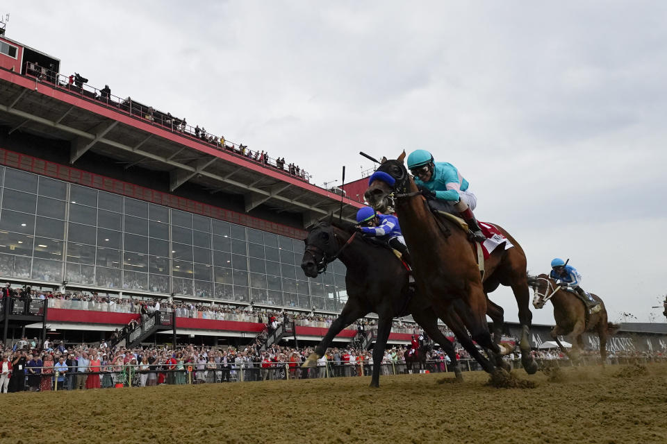 National Treasure, right, with jockey John Velazquez, edges out Blazing Sevens, with jockey Irad Ortiz Jr., to win the148th running of the Preakness Stakes horse race at Pimlico Race Course, Saturday, May 20, 2023, in Baltimore. (AP Photo/Julio Cortez)