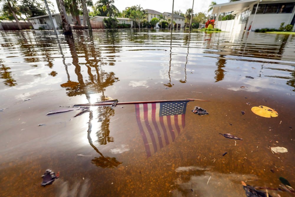 An American flag sits in the floodwaters from Hurricane Helene in the Shore Acres neighborhood of St. Petersburg, Fla. on Sept. 27. <span class="copyright">Mike Carlson—AP</span>