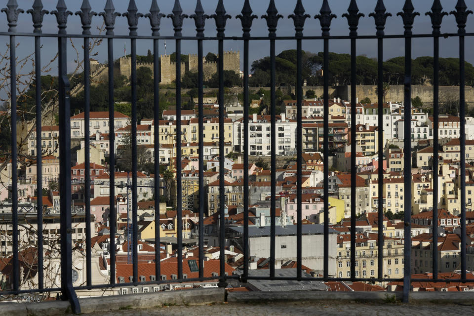 A view of the Castle neighborhood, below the 14th-century St. George's Castle, from a public garden in Lisbon, Monday, Feb. 27, 2023. Rosa Santos, a 59-year-old born and raised close to St. George's Castle overlooking the port city, says most homes in her neighborhood are occupied by short-term vacation rentals, largely for foreign tourists. (AP Photo/Armando Franca)