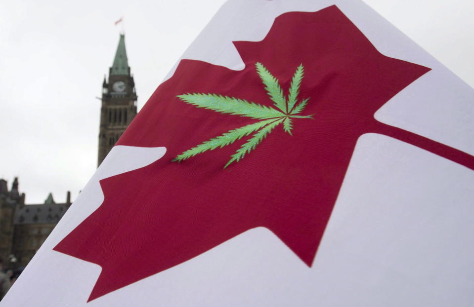 A Canadian flag with a cannabis leaf flies on Parliament Hill during the 4/20 protest, Monday, April 20, 2015 in Ottawa. (THE CANADIAN PRESS/Adrian Wyld)