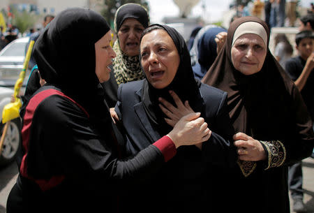 FILE PHOTO: The mother (C) of 17-year-old Palestinina Nadim Nuwara mourns during his funeral in the occupied West Bank in Ramallah May 16, 2014. REUTERS/Ammar Awad/File Photo