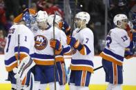 Jan 18, 2019; Washington, DC, USA; New York Islanders goaltender Thomas Greiss (1) celebrates with Islanders defenseman Nick Leddy (2) after their game against the Washington Capitals at Capital One Arena. The Islanders won 2-0. Mandatory Credit: Geoff Burke-USA TODAY Sports