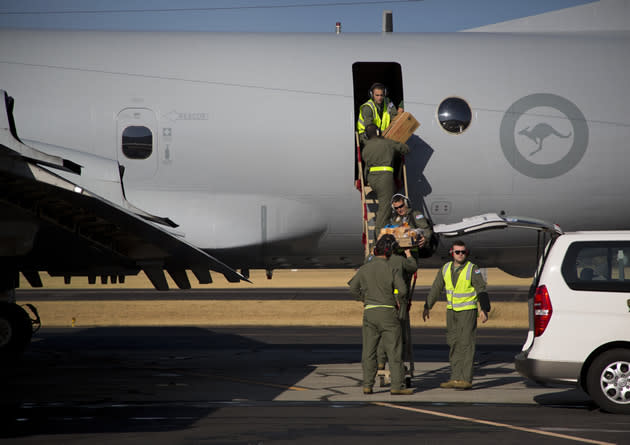 Australian pilots load up a search plane with supplies before joining the ongoing international search for the missing flight MH370. (Getty Images)