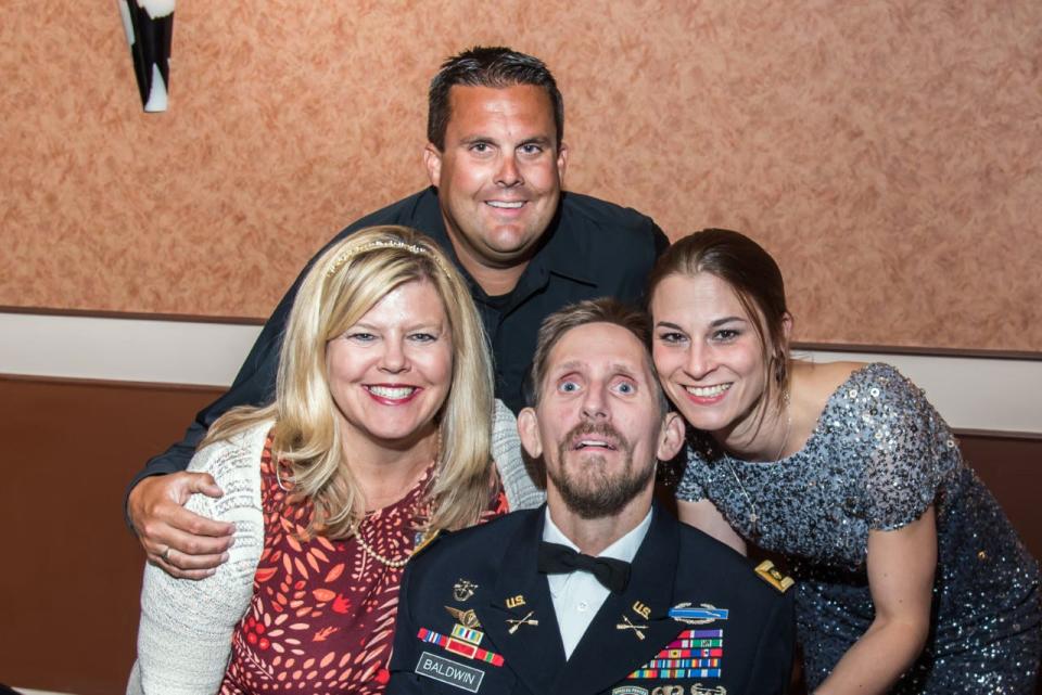 Maj. Darren Baldwin is pictured with his sister, Veronica Asbury-Frollini (left); her husband, David Frollini; and his wife, Bianca.