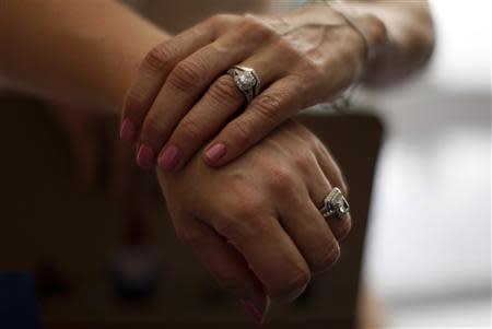 Sallee Taylor, 41, (L) and her wife Andrea Taylor, 41, hold hands after getting married in West Hollywood, California, July 1, 2013. REUTERS/Lucy Nicholson