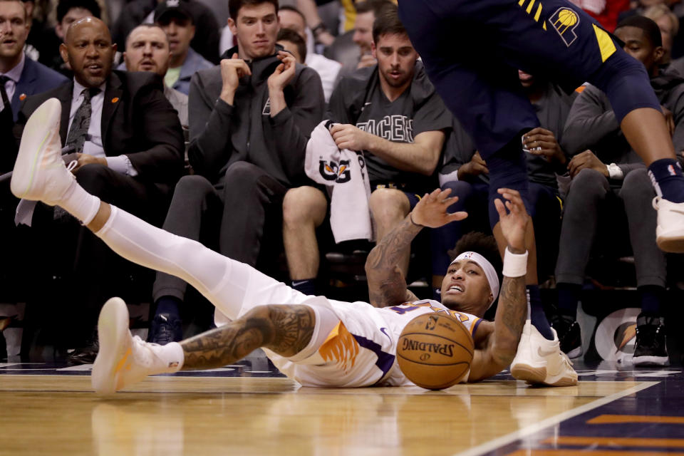 Phoenix Suns forward Kelly Oubre Jr. tries to save the ball from going out of bounds against the Indiana Pacers during the first half of an NBA basketball game, Wednesday, Jan. 22, 2020, in Phoenix. (AP Photo/Matt York)