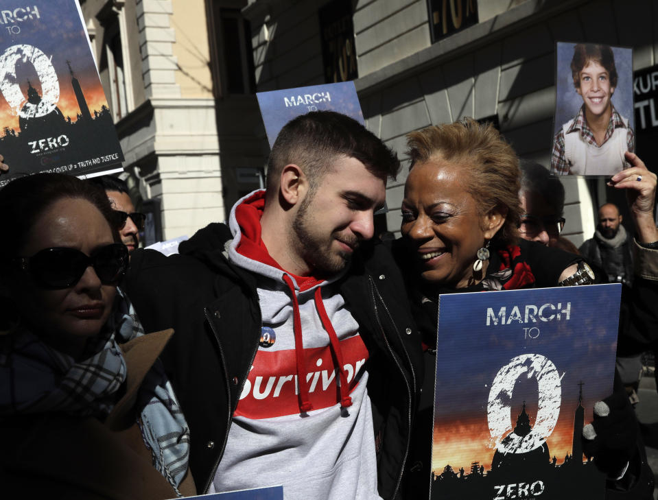 Sex abuse survivor Alessandro Battaglia is hugged by survivor and founding member of the ECA (Ending Clergy Abuse), Denise Buchanan, right, during a march in Rome, Saturday, Feb. 23, 2019. Pope Francis is hosting a four-day summit on preventing clergy sexual abuse, a high-stakes meeting designed to impress on Catholic bishops around the world that the problem is global and that there are consequences if they cover it up. (AP Photo/Alessandra Tarantino)