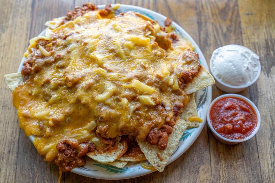 Lupie’s Cafe has been serving comfort food in Charlotte for 34 years. Shown above is its nachos with chili, cheese, sour cream and salsa.