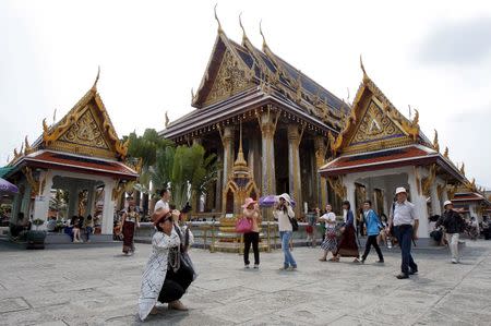 Chinese tourists visit Wat Phra Kaeo (Emerald Buddha Temple) in Bangkok March 23, 2015. TOURISM REUTERS/Chaiwat Subprasom